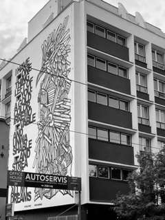 Large commercial building with streetart and words on the side of the building